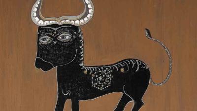 A stylized black bull with large, ornate silver horns and a patterned body.